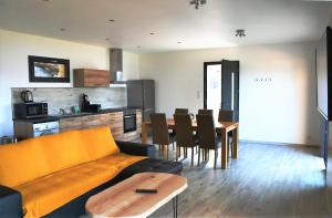 a living room with a couch and a table at Cosy vue mer in Olmeto +7 photos