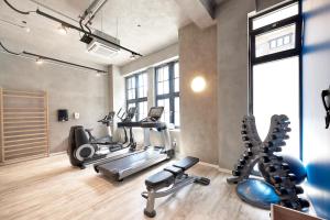 a gym with two treadmills and two exercise machines at Catalonia Berlin Mitte in Berlin