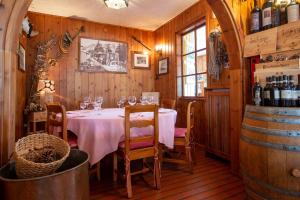 a dining room with a table with wine glasses at Baita De Mario in Valdisotto
