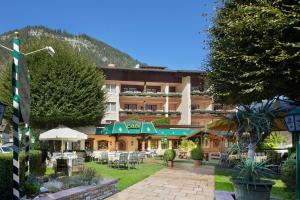 a hotel with tables and chairs in a courtyard at Hotel Alpenhof Kristall in Mayrhofen