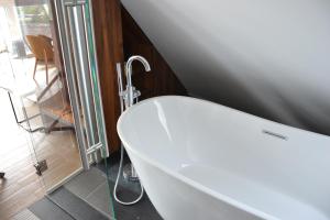 a bath tub sitting in a bathroom next to a window at Apollo Hotel Vienna in Vienna
