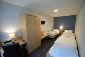 Postel nebo postele na pokoji v ubytování Hotel Restaurant Tychon AG