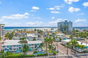 an aerial view of a resort with palm trees and the ocean at Hollywood Beachside Boutique Suite in Hollywood
