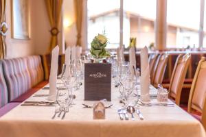 a table with wine glasses and napkins on it at Hotel Alpen-Royal in Jerzens