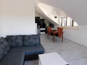 a living room with a couch and a table at Villa Renata - Apartment Bijeli in Povlja