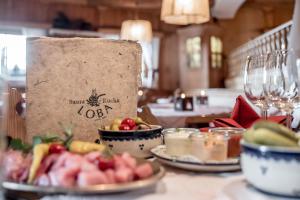 a table with plates of food and a paper bag at Appartement Loba in Ischgl