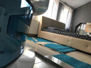 a living room with a couch and a mirror at Hotelwhite Family Gjilan in Gjilan