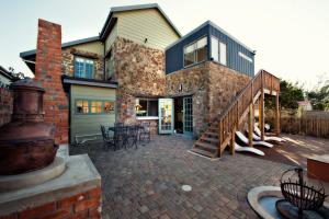 a large brick house with a patio and a garage at Funky Town in Jeffreys Bay