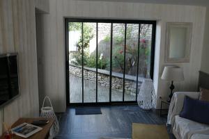 a living room with a large sliding glass door at Magnifique rétaise-hyper centre le Bois-Plage-en-Ré in Le Bois-Plage-en-Ré