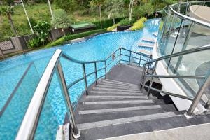 a staircase leading up to a large swimming pool at Delmare Beachfront Bangsaray Premium Condominium in Bang Sare