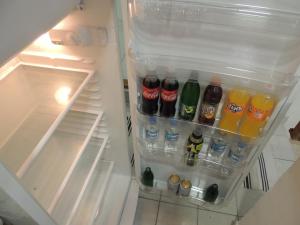 an open refrigerator filled with bottles and drinks at APARTMAN AZRA in Sarajevo
