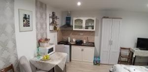 a kitchen with a table with a microwave on it at Huncovská 14 in Košice