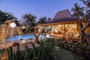 a house with a pool in front of it at Kuno Villas in Gili Trawangan +60 photos