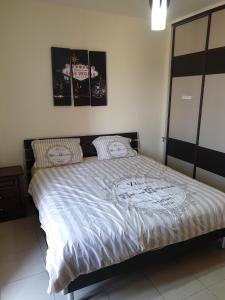 un letto con piumone bianco in una camera da letto di Sea View Apartment at Tala Bay Resort in Aqaba ad Aqaba
