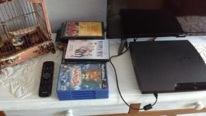a table with two dvds and a computer on it at Apartamento "La Bombilla" in Madrid