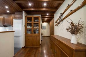 a kitchen with wooden ceilings and a white refrigerator at GERBER de Alma de Nieve in Baqueira-Beret +3 photos
