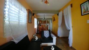 a living room with a couch and a window at Casa Tania Fernandez in Viñales