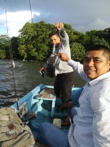 two men on a boat in the water at Caballito's Mar in Mérida