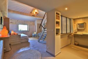 a bedroom with a bunk bed and a staircase in it at Le Mas Des Brunes in Saint-Laurent-dʼAigouze