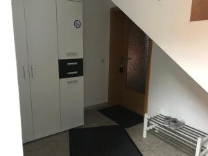 a hallway with a staircase leading to a room at Ipf Blick Ferienwohnung in Bopfingen +17 photos
