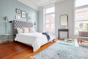 a bedroom with a large bed and a mirror at Sonder The Broughton in Savannah
