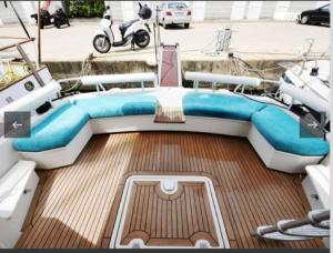 a boat with a blue bed on the deck at Beautiful Kiwi Boat in Barcelona