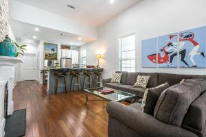 a living room with a couch and a table at Cozy and Charming House with Luxury Amenities in New Orleans