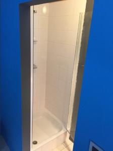 a bathroom with a shower with a white tub at Studio Colette - Spa Centre in Spa