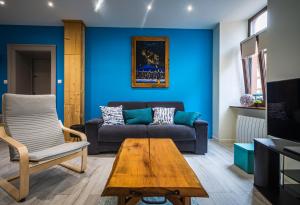 a living room with a couch and a table at LA LIESE in Niederbronn-les-Bains