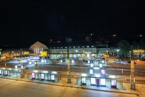 a parking lot at night with cars parked at #centralstation #130qm Hauptbahnhof #netflix in Karlsruhe