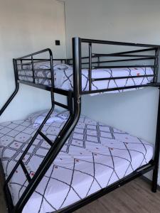 a pair of bunk beds in a room at LACANAU FRONT DE MER in Lacanau