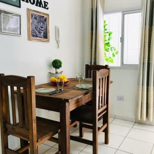 ポサーダスにあるItá Apartのダイニングルームテーブル、椅子、木製テーブル、窓