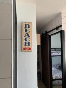 a sign hanging on a wall next to a door at LACANAU FRONT DE MER in Lacanau
