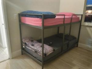 מיטה או מיטות קומותיים בחדר ב-Miami Cheapest Place