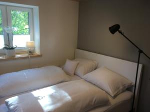 a bed with two pillows on it in a room at Wohnung in zentraler Lage im Rheintal in Götzis