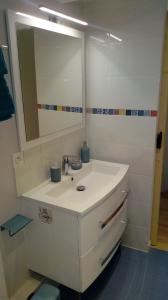 a bathroom with a white sink and a mirror at Maison au pied de la cathédrale in Elne