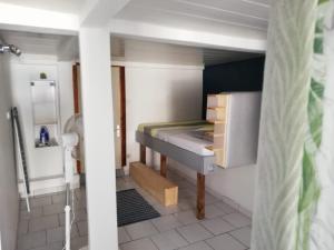 a small bedroom with a bunk bed in it at Studio transit sur la route des plages in Le Marin