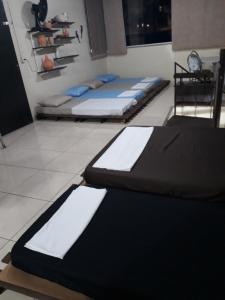 a room with three mattresses sitting on the floor at Sótão Oktoberfest in Blumenau