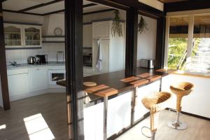 a kitchen with a counter and some chairs in it at Wolfs Ferienhaus - Natürlich Eifel in Blankenheim