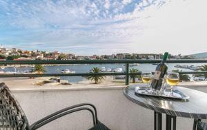 a table with two glasses of wine on a balcony at Apartments Mare - 30m from beach in Seget Vranjica