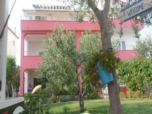 a tree with a blue bucket hanging from a street sign at Apartments Mare - 30m from beach in Seget Vranjica