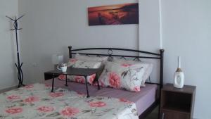 a bedroom with a bed with pink and white pillows at Melina΄s apartment in Serres