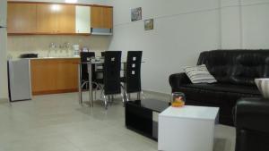 a living room with a couch and a table and a kitchen at Melina΄s apartment in Serres
