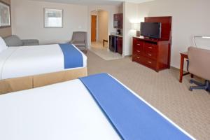 a hotel room with two beds and a flat screen tv at Holiday Inn Express & Suites College Station, an IHG Hotel in College Station