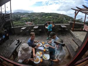 a group of people sitting around a table eating food at Cabinas Vista Al Golfo in Monteverde Costa Rica +131 photos