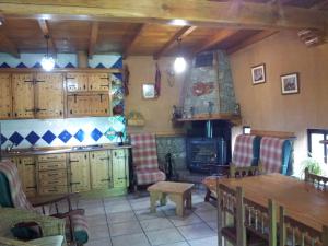 吉霍－德聖巴巴拉的住宿－Casa Rural Santa Bárbara，客厅配有桌椅和壁炉