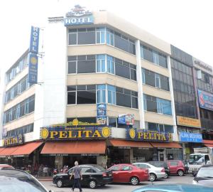a man walking in front of a hotel at Palm Inn Ampang Point in Ampang