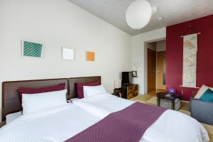 a bedroom with a large bed and a couch at Viale Jurakumawari in Kyoto