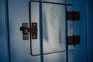 a close up of a blue door with rain on it at Trojan House in Ensenada