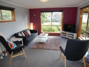 a living room with a couch and a tv at Holiday home by the beach in St Helens in St Helens